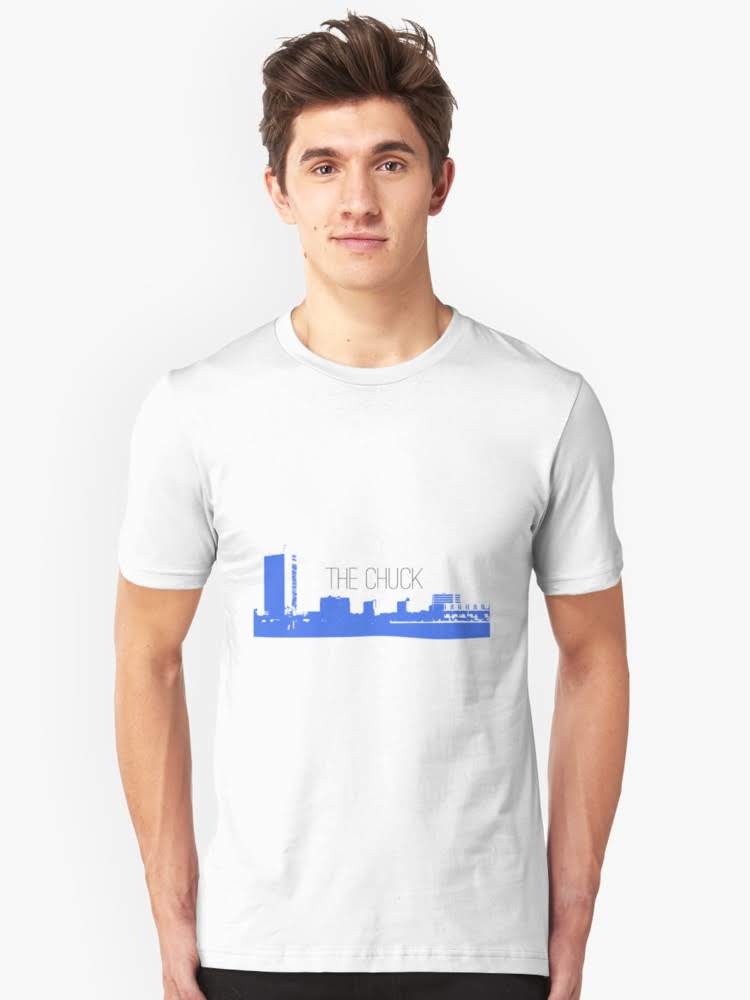 Man wearing a white THE CHUCK t-shirt with a city skyline graphic