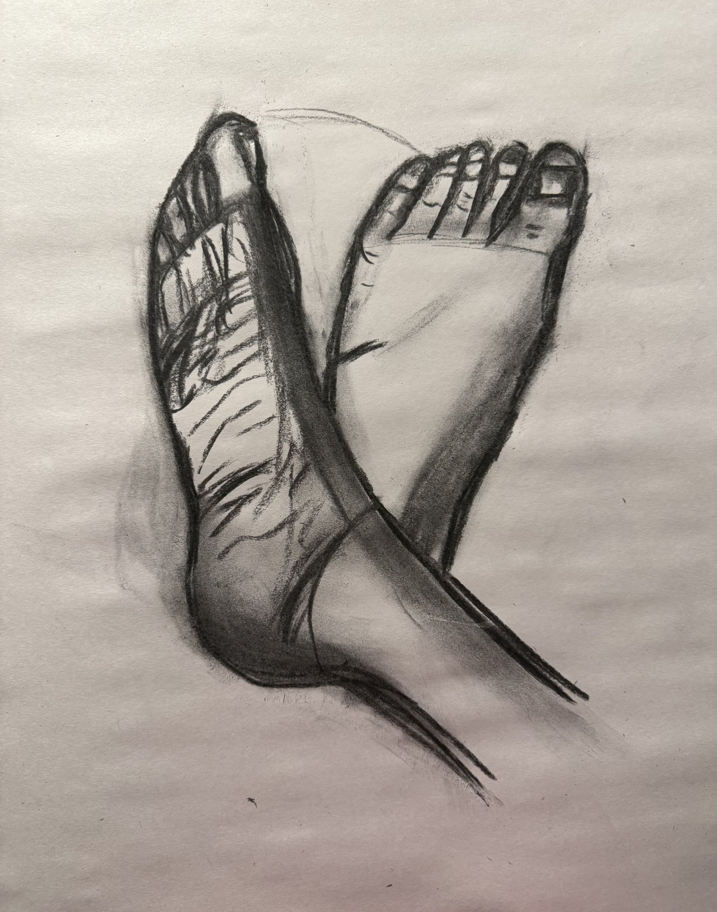 Charcoal study of two crossed feet