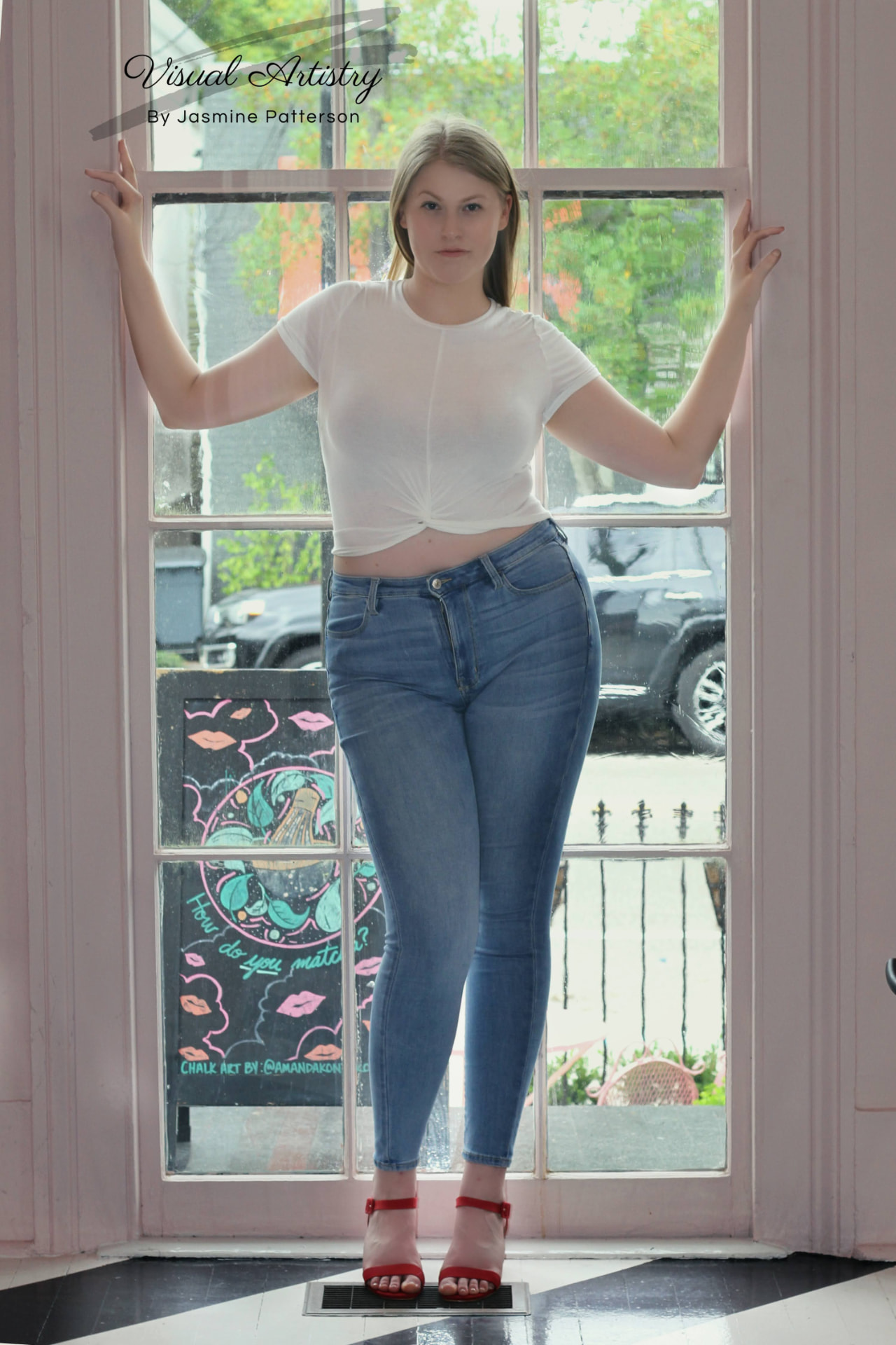 Woman standing in a café doorway framed by tall windows