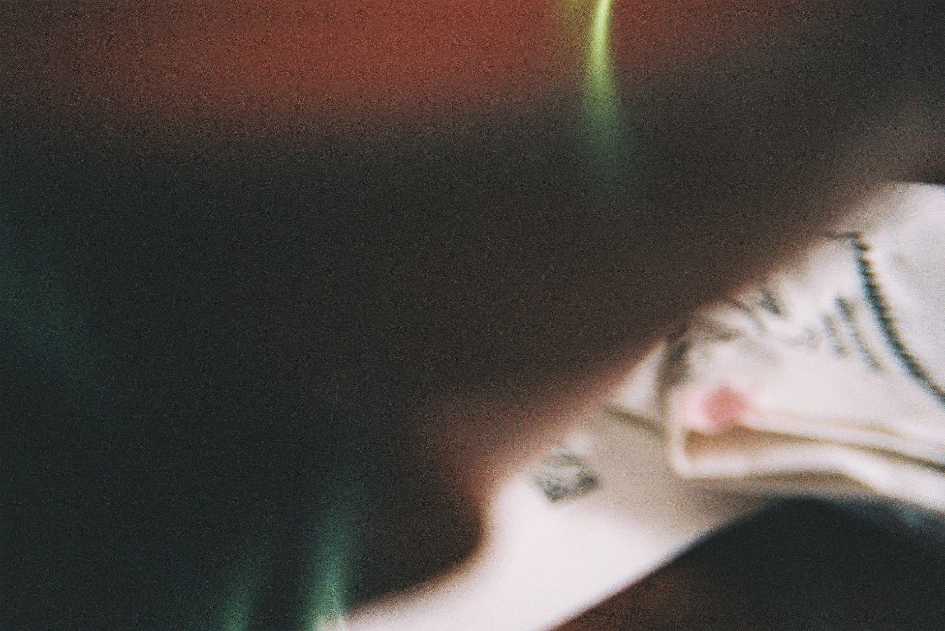 Dreamy blurred 35mm frame with strands of hair crossing the viewfinder