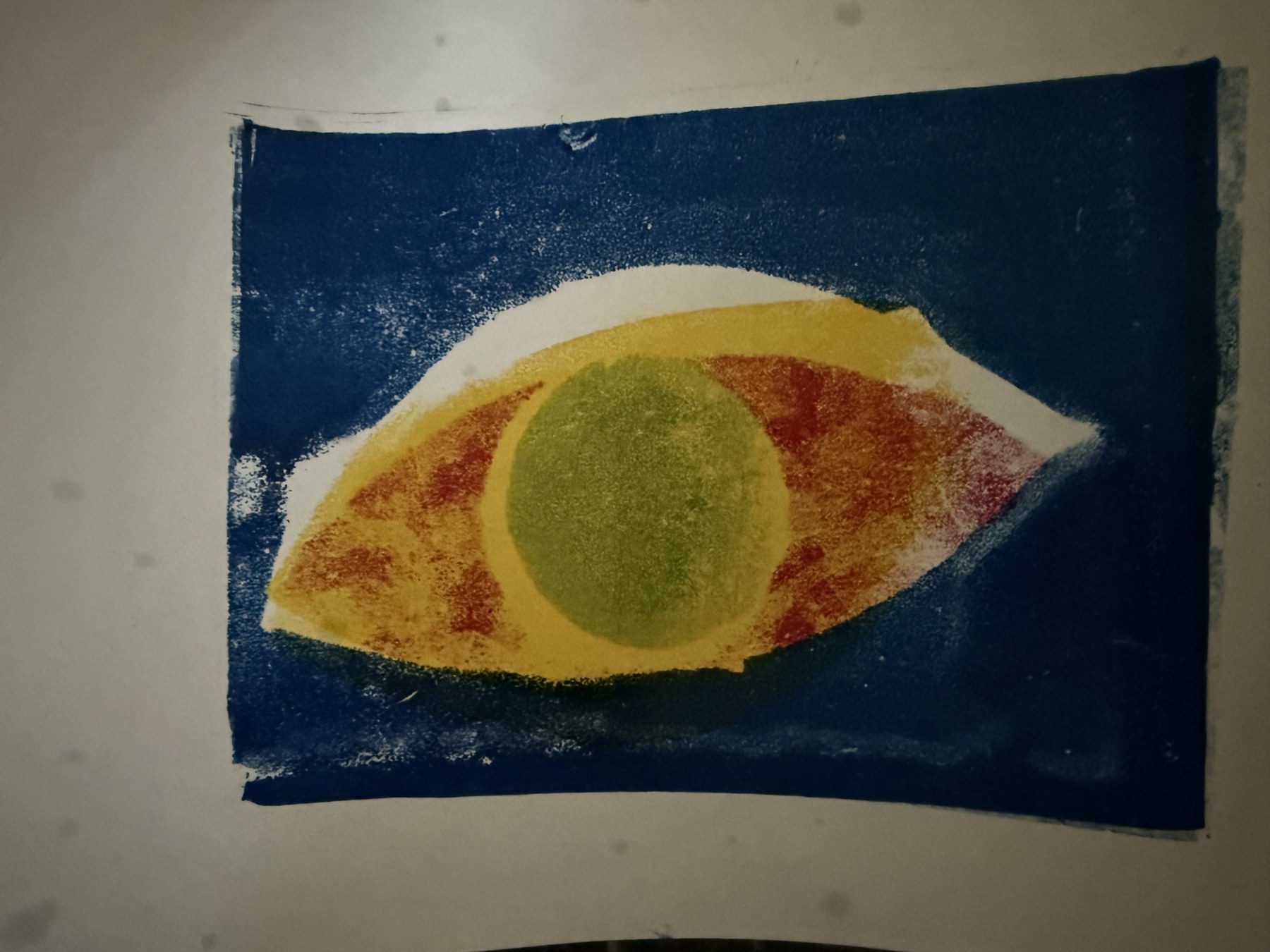 Cyanotype-style eye print in blue with a green pupil