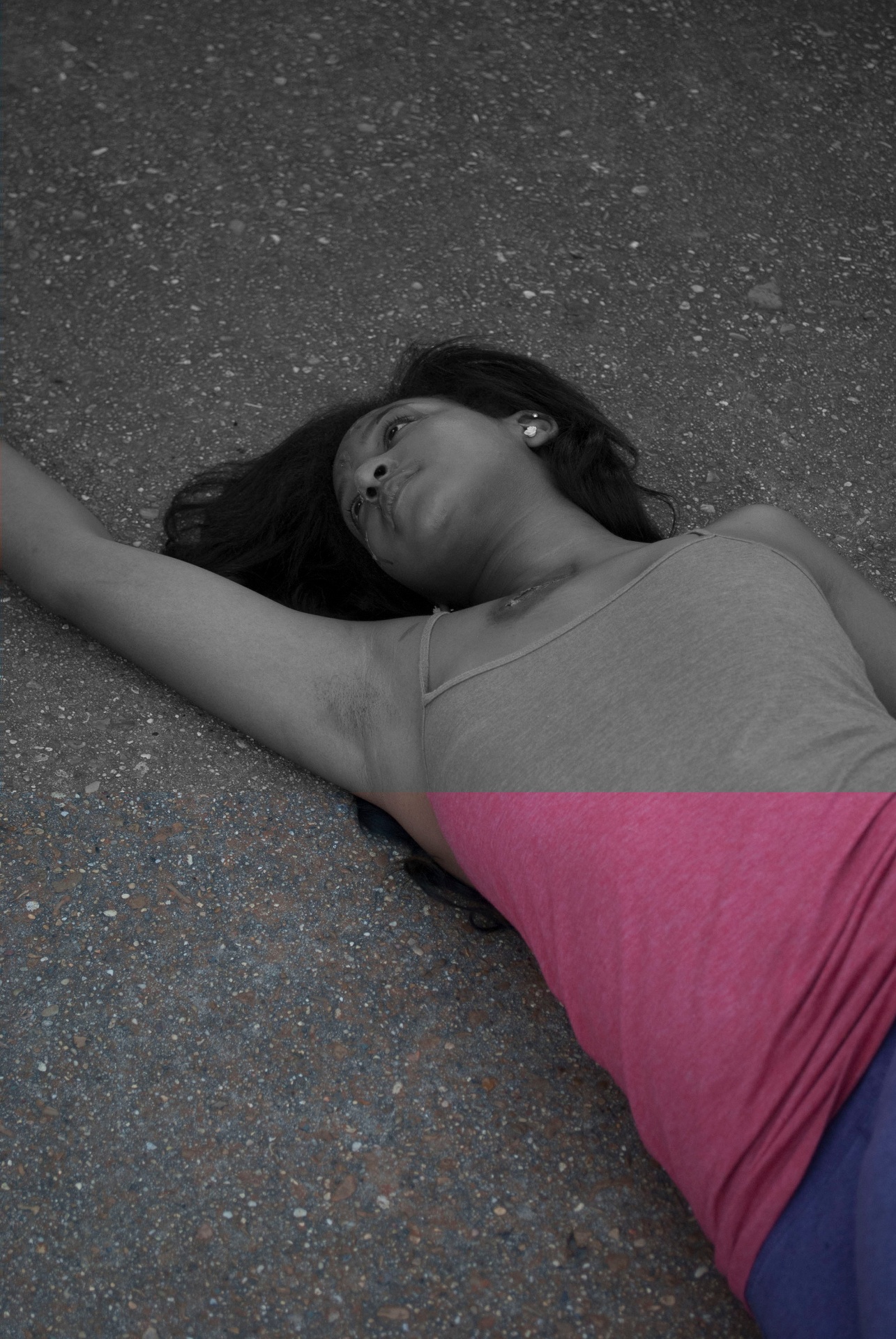 Track runner lying on pavement, rendered mostly in black and white with selective pink color