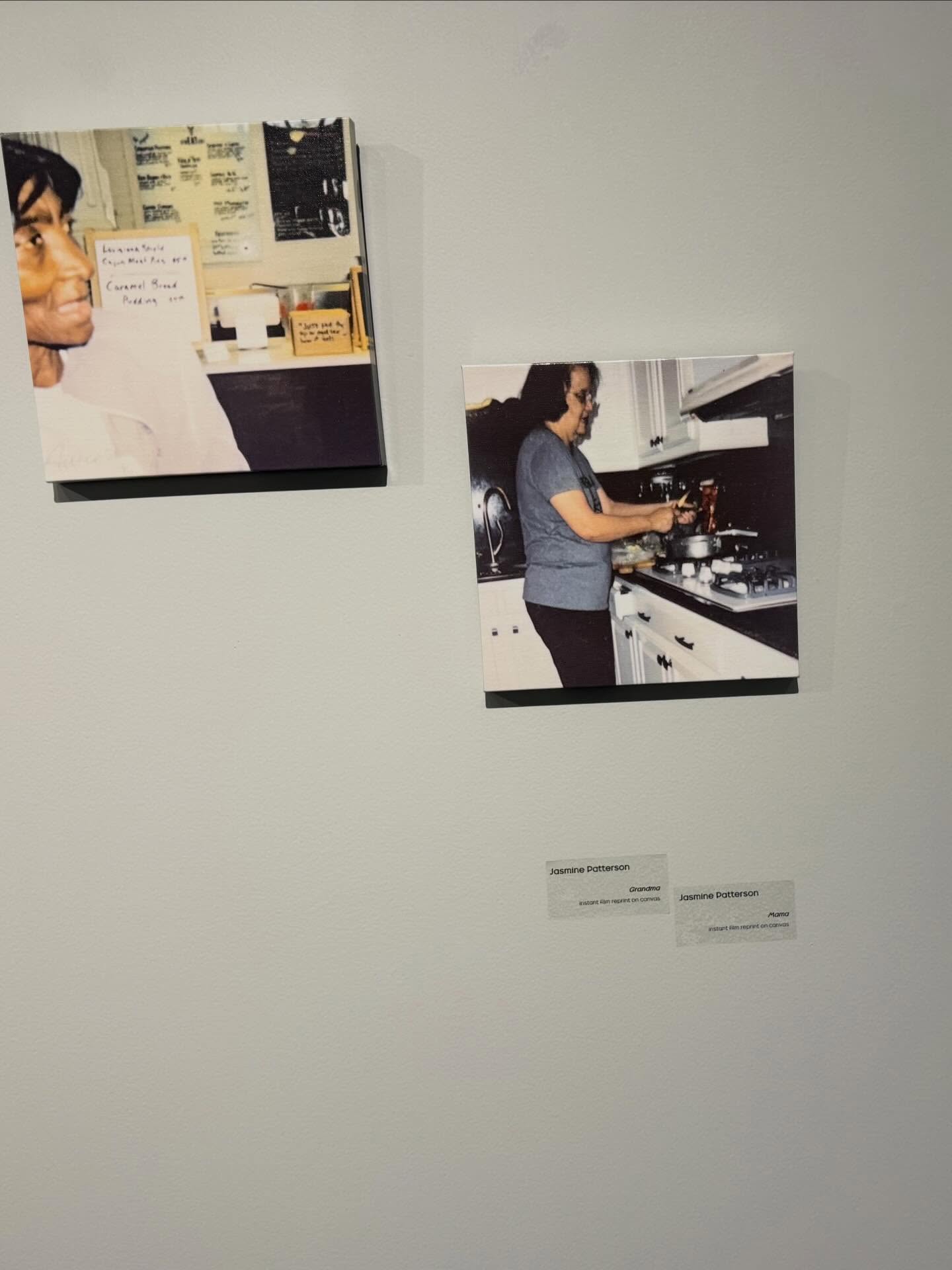 Gallery wall at the Visual Arts Alumni Exhibition showing Jasmine Patterson's framed kitchen photographs with labels