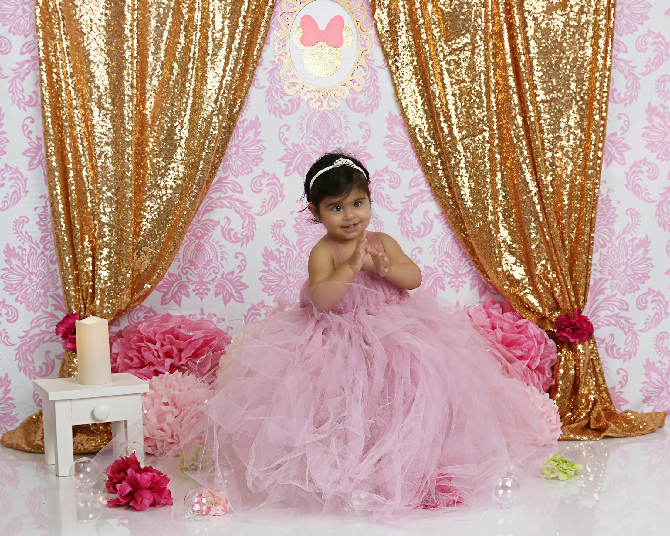 Toddler in a pink tulle dress on a Minnie Mouse birthday set