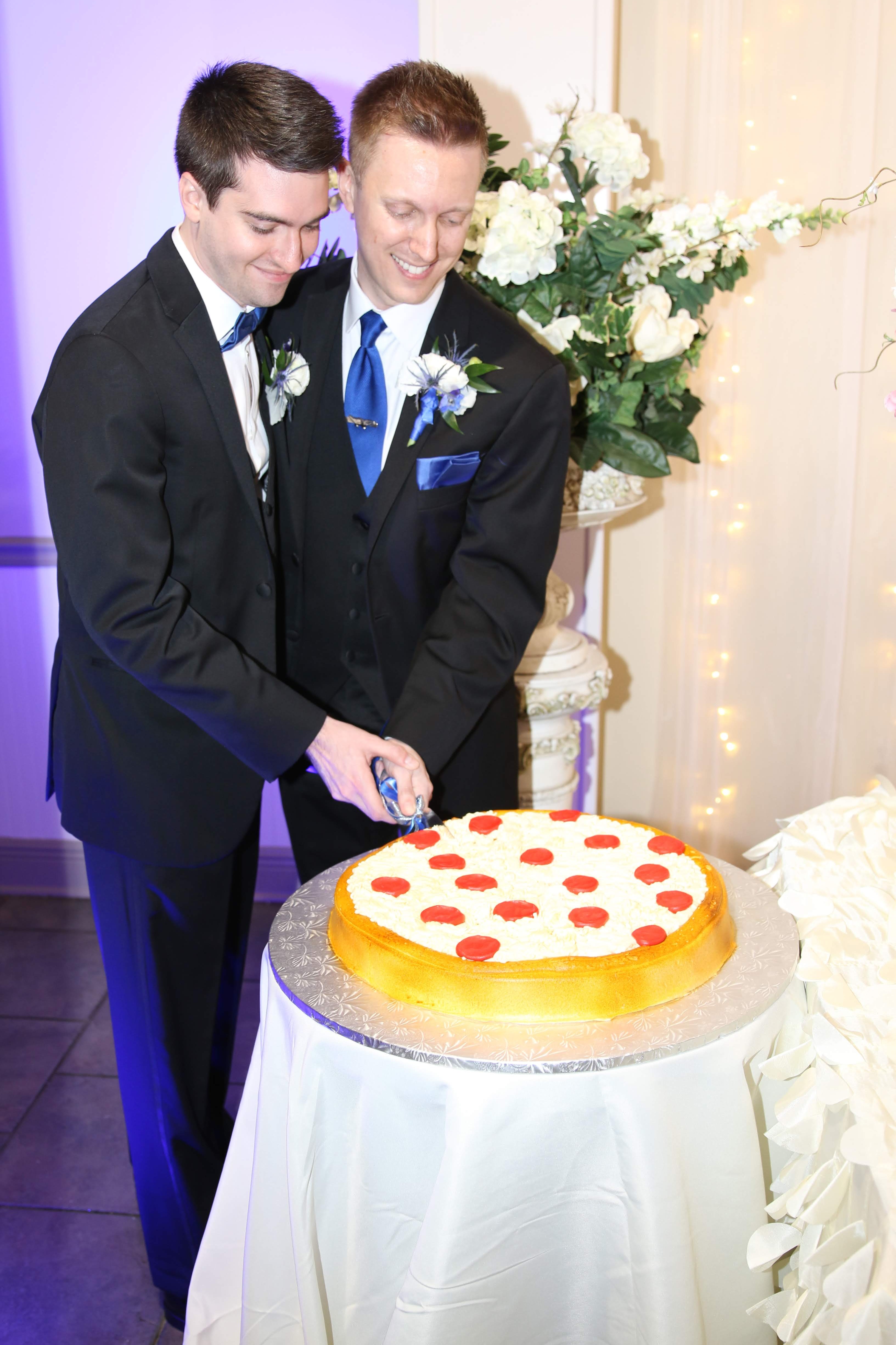 Newlyweds cutting the wedding cake together