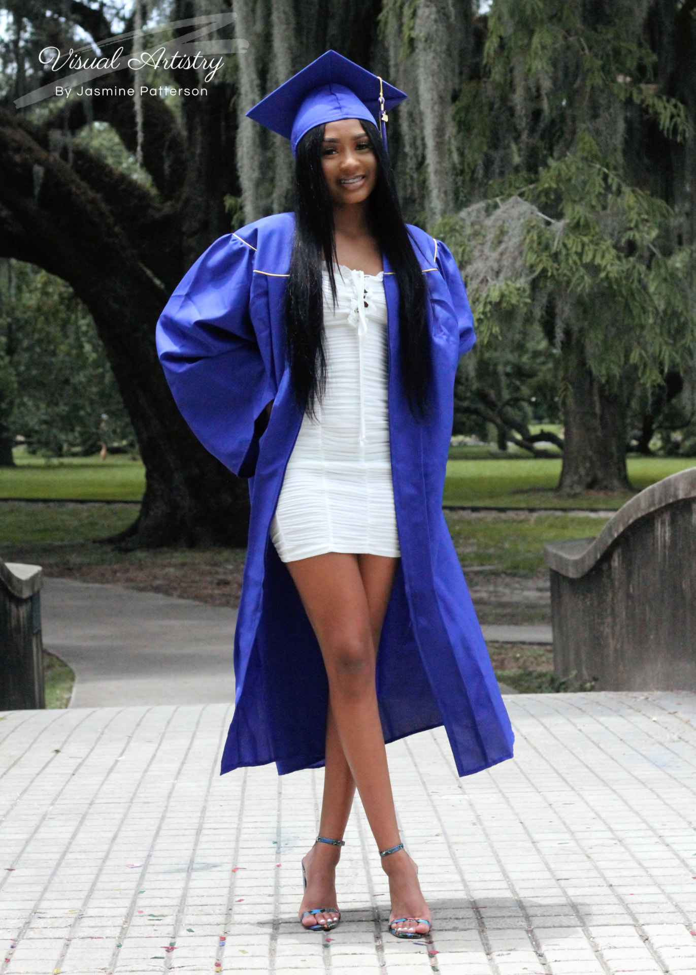 Graduate in a blue gown over a white dress