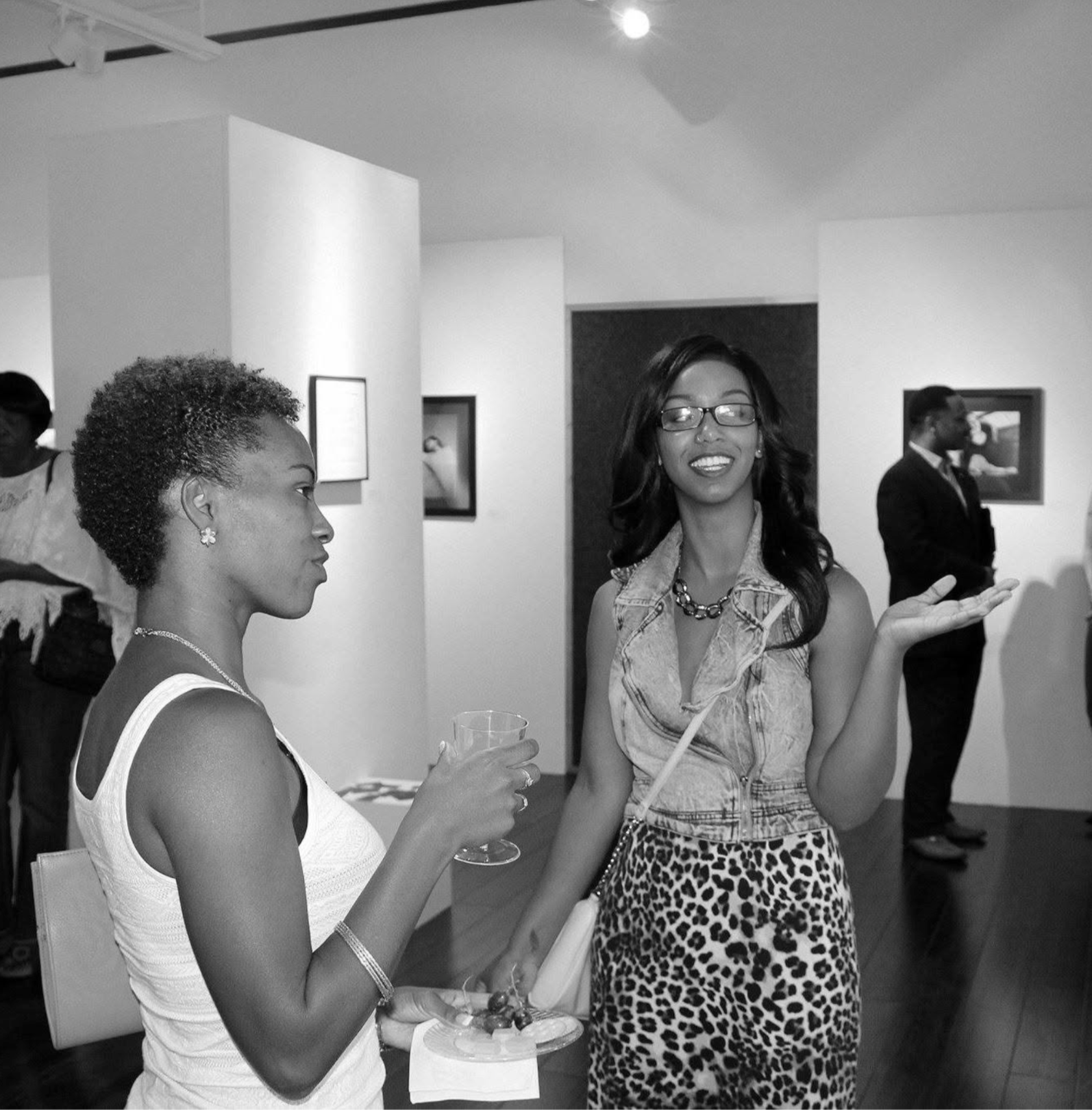 Black-and-white photo of Jasmine Patterson with a guest during the exhibition
