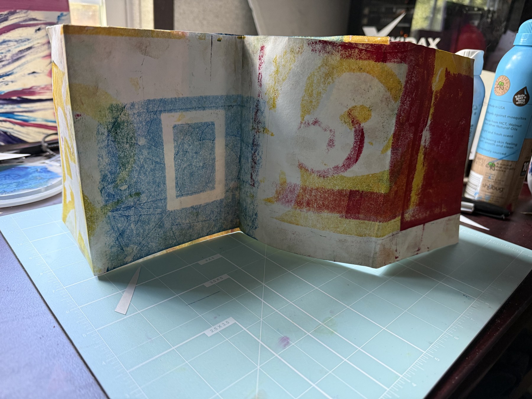 Hand-bound accordion artist book with colorful printed panels