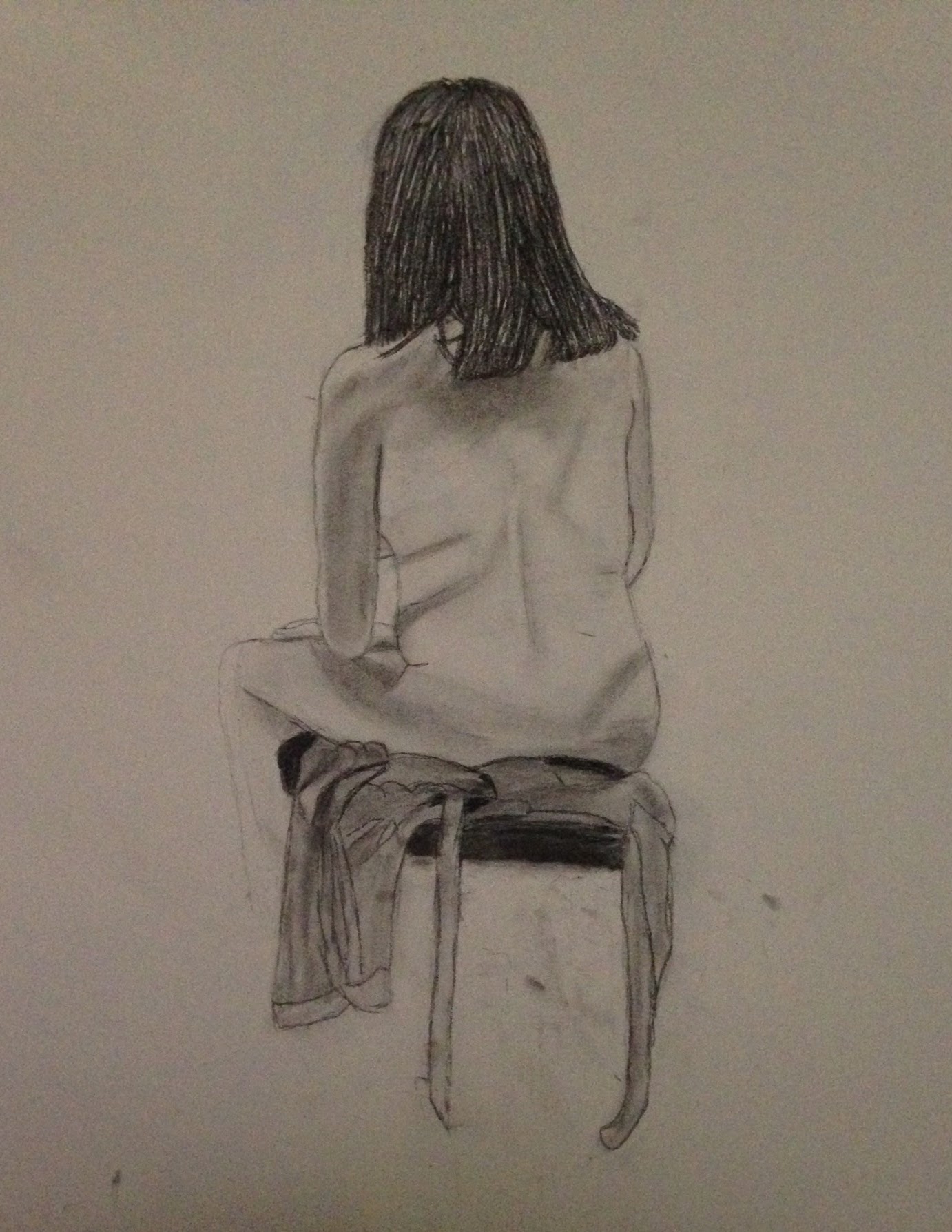 Graphite drawing of a seated figure seen from behind